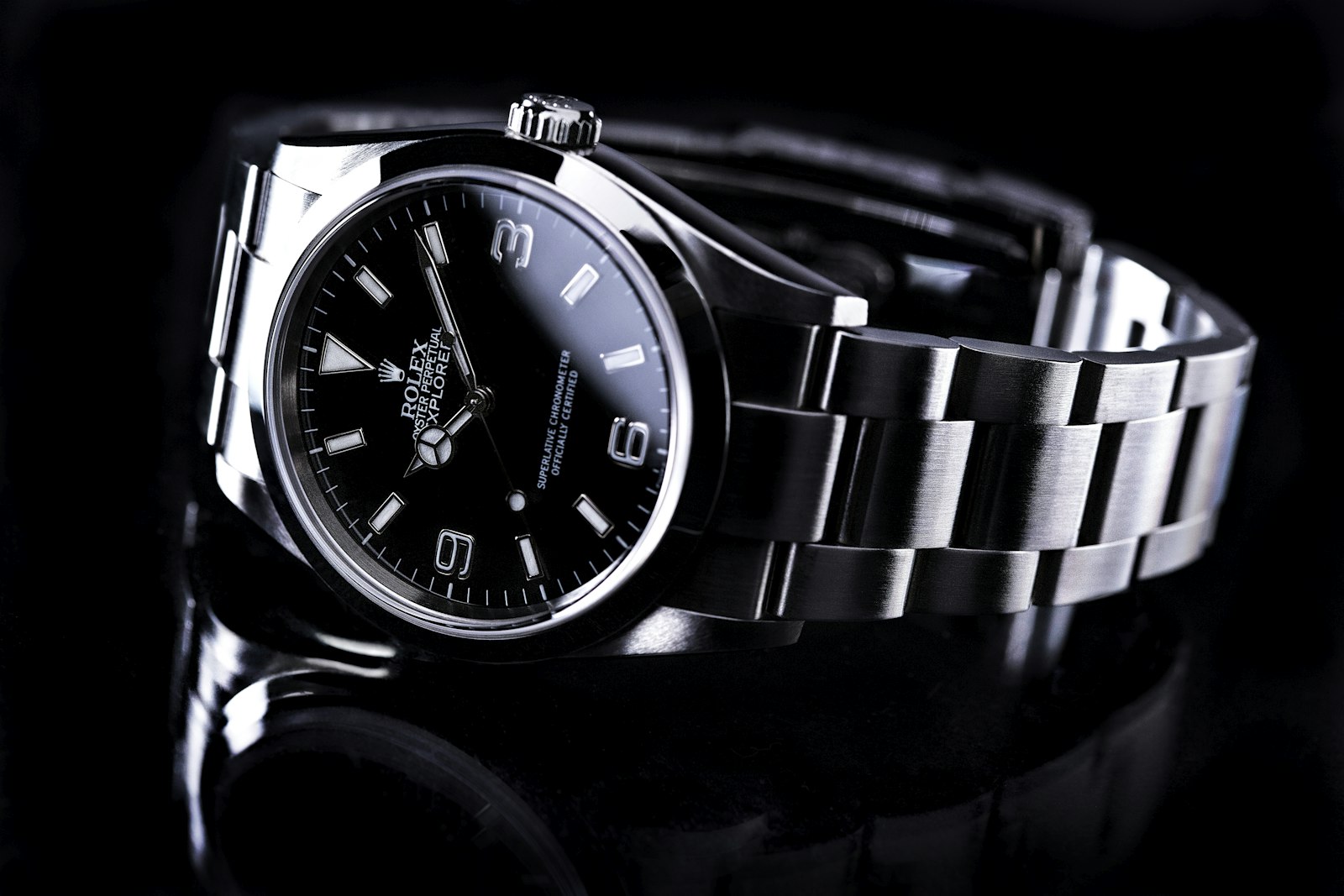 A steel Rolex Explorer photographed on black